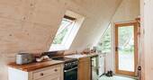 Kitchen equipped with an oven, stove, kettle, toaster and undercounter fridge