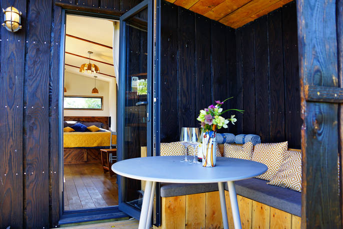Outdoor seating area can be accessed from the cabin