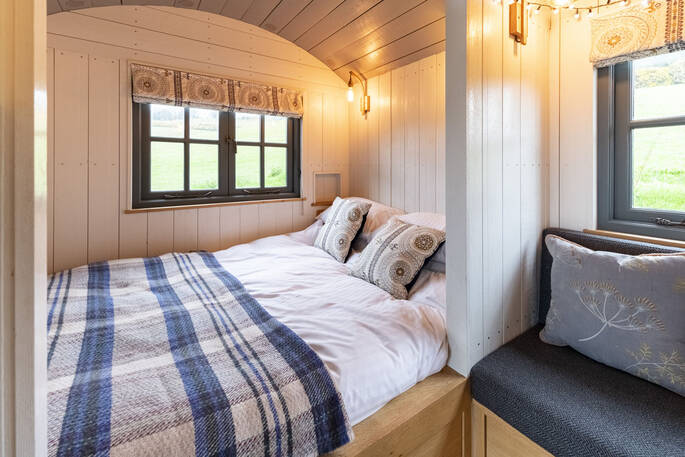 Enjoy breathtaking views of the Somerset countryside through the window from the comfort of your kingsize bed at Tilbury Herdwick shepherd's hut 