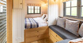 Relax in the cosy double bed inside Tilbury Herdwick shepherd's hut in Somerset