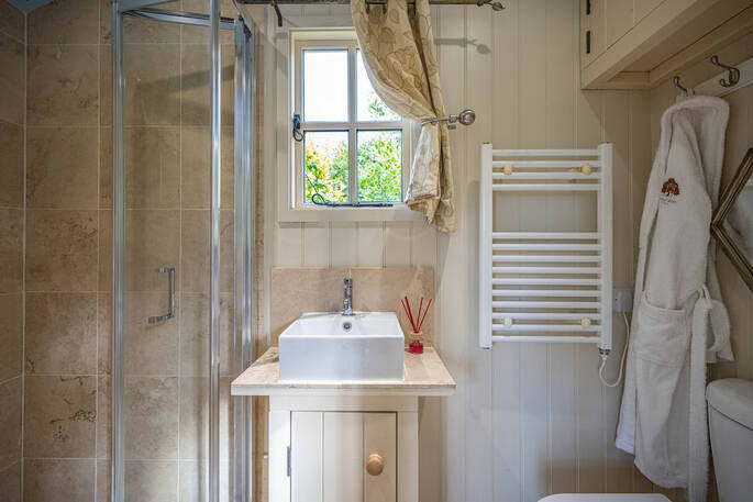 Bathroom with a hot shower, sink and flushing toilet