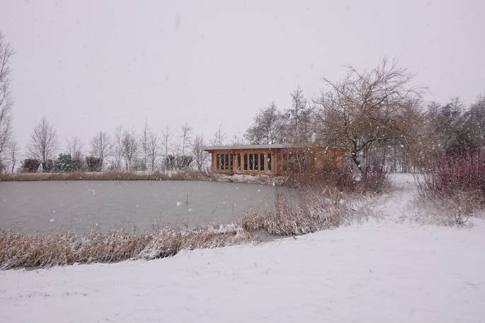 Russet Lodge cabin during winter snow at Blyth Rise Stays, Laxfield, Suffolk