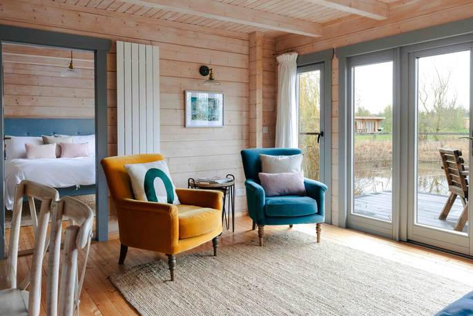 Russet Lodge cabin living room with view to the pond, Laxfield, Suffolk, England