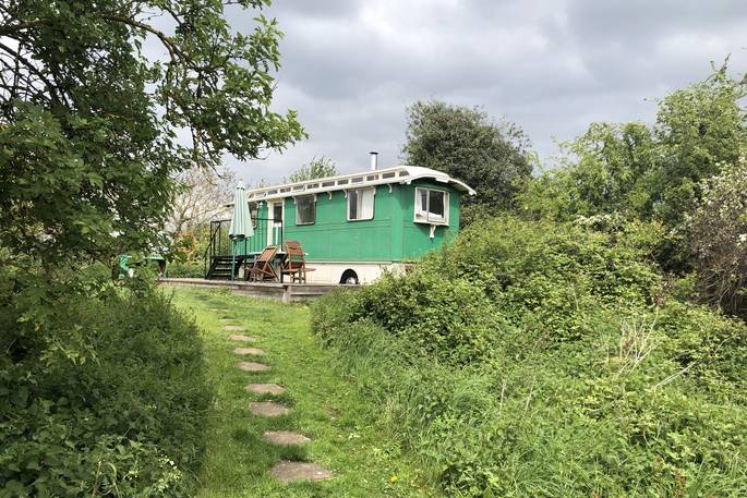 An exterior view of the Green Fairground Wagon in Suffolk