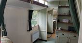 The cosy cottage-like interior of Green Fairground Wagon in Suffolk