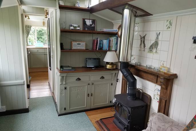 The cosy interior of Green Fairground Wagon in Suffolk