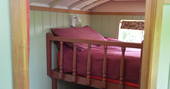 Bunk room inside Maroon Fairground Wagon at Coppins Farm in Suffolk