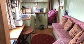 Kitchen and living area inside Maroon Fairground Wagon at Coppins Farm in Suffolk