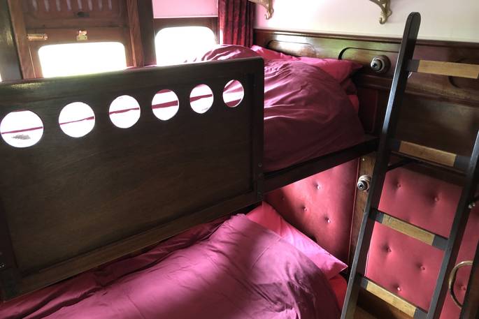 Bunk beds inside The Victorian Railway Carriage at Coppins Farm in Suffolk