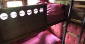 Bunk beds inside The Victorian Railway Carriage at Coppins Farm in Suffolk