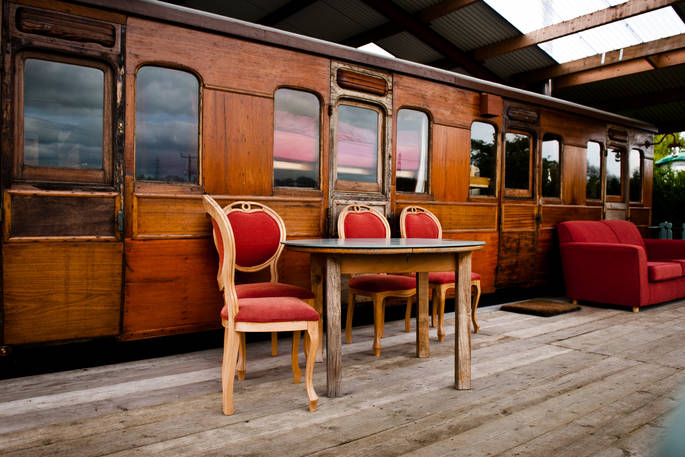 Exterior of The Victorian Railway Carriage with outdoor seating at Coppins Farm in Suffolk