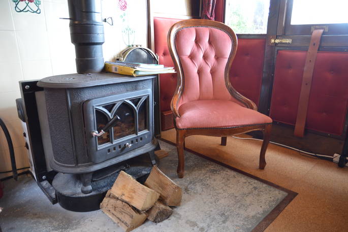Light the wood-burner and relax inside The Victorian Railway Carriage at Coppins Farm in Suffolk