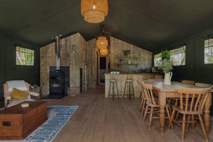 Interior of The Artists Retreat with wood-burner and fully equipped kitchen at The Lost Garden Retreat in Suffolk
