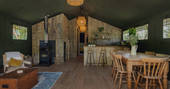 Interior of The Artists Retreat with wood-burner and fully equipped kitchen at The Lost Garden Retreat in Suffolk