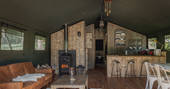 Interior of The Cowshed with wood-burner and fully equipped kitchen at The Lost Garden Retreat in Suffolk