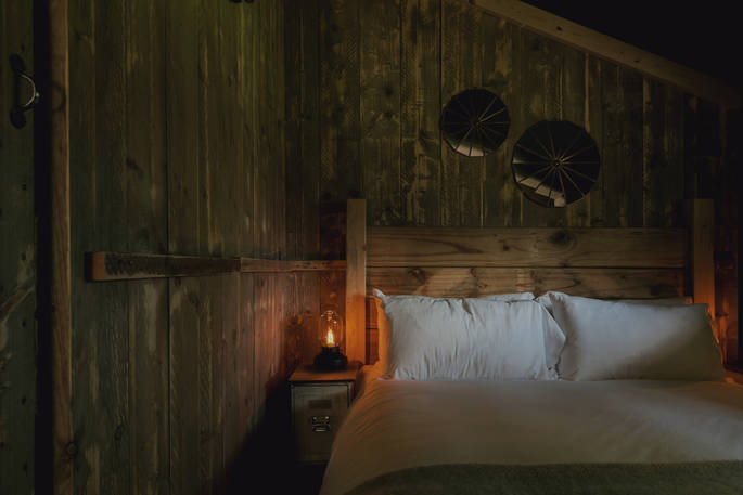 King-size bed inside The Cowshed at The Lost Garden Retreat in Suffolk