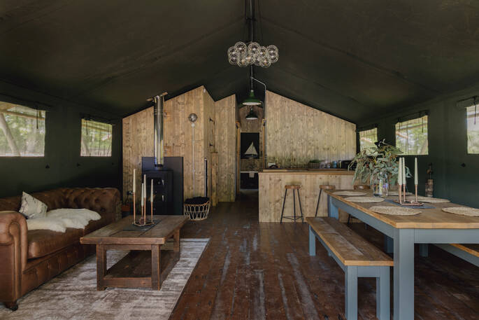 Interior of The Fisherman's Hideaway with wood-burner and fully equipped kitchen at The Lost Garden Retreat in Suffolk