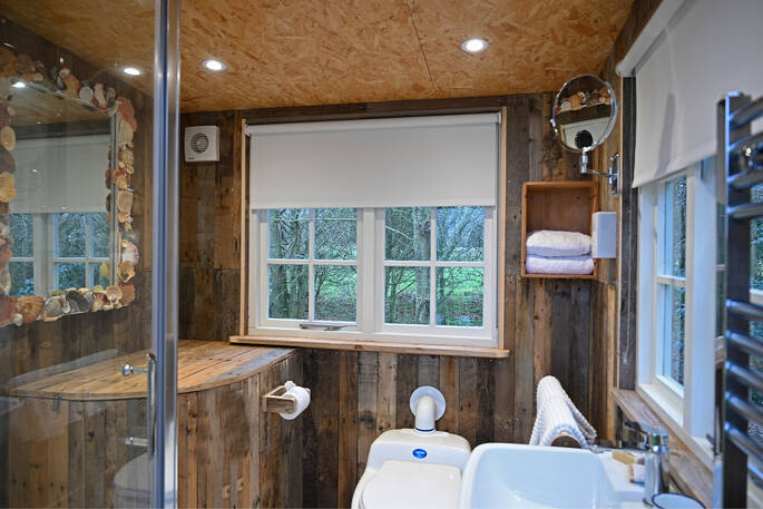 Bathroom has a shower, sink and compost loo