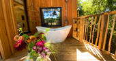 outdoors bathtub at Meadow Cabin at Beneath The Branches, Sussex