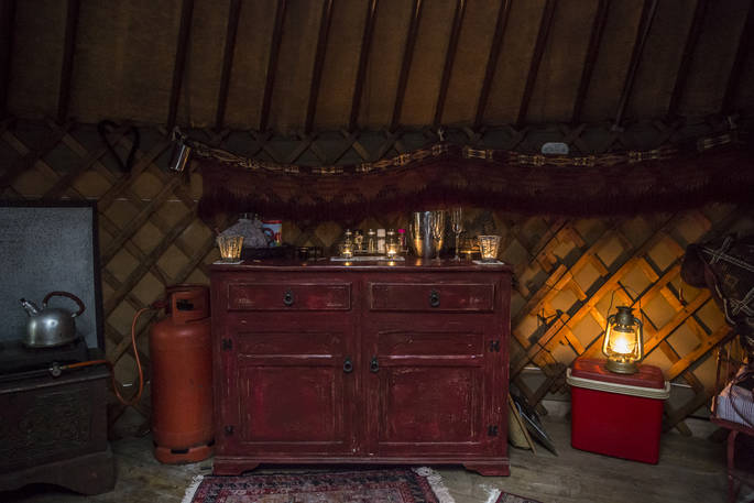Inside the cosy and rustic Kushti yurt at Forest Garden in Sussex