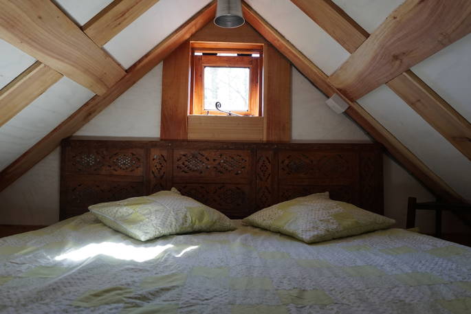 The double bed at Orinoco Cabin on the mezzanine level up in the rafters 