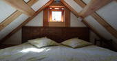The double bed at Orinoco Cabin on the mezzanine level up in the rafters 
