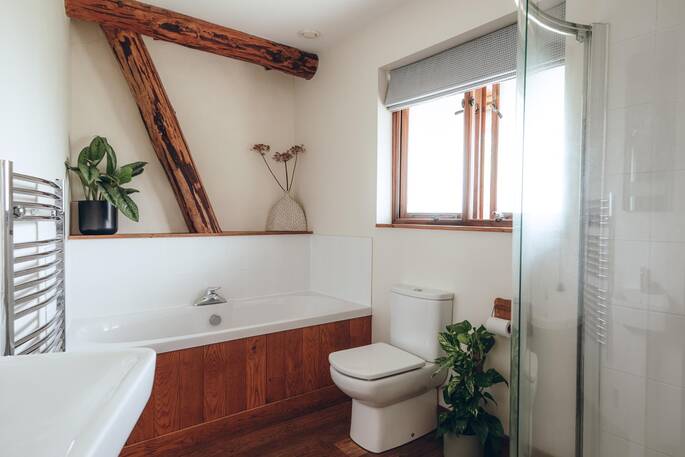 Second bathroom with a bath, shower and flushing toilet