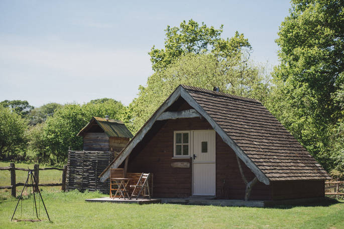 An exterior shot of Penfold Cabin basking in the sunshine in Sussex