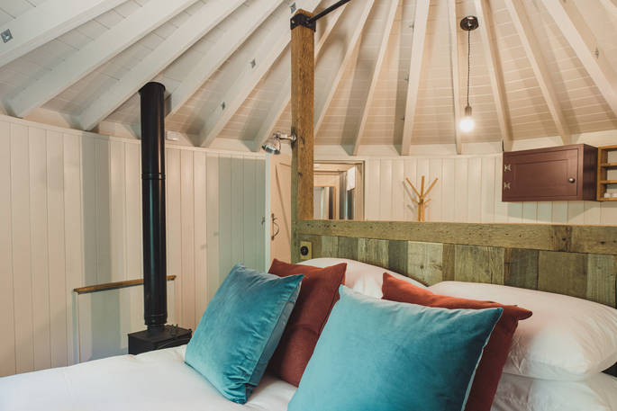 Kick back on the bed and admire the crafted Sussex Round House in Sussex