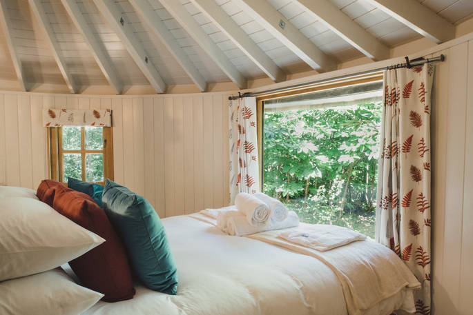 Look out at the woodland surrounding you from your bed at The Sussex Roundhouse in Sussex