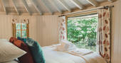 Look out at the woodland surrounding you from your bed at The Sussex Roundhouse in Sussex