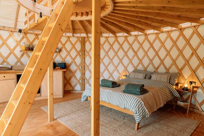 Bed under the mezzanine with dining area