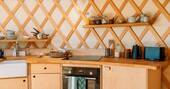 Kitchen equipped with an oven, electric hob, kettle and toaster