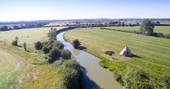 Aerial view of Slinket next to the quiet curve of the Oxford Canal at Hill Farm Glamping