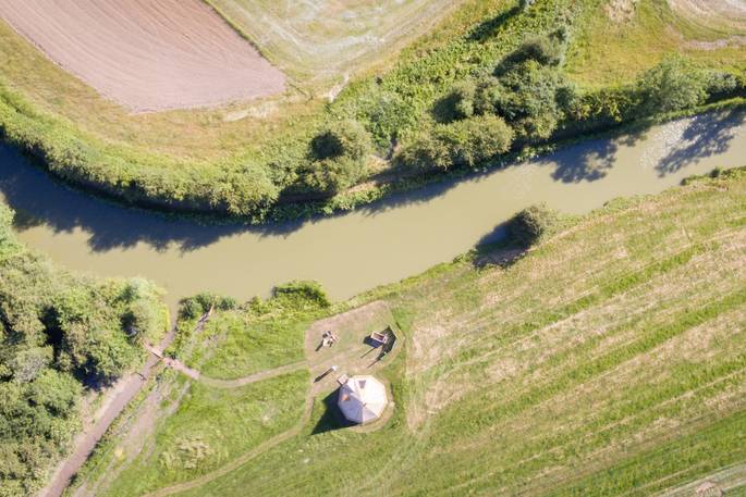 Aerial view of Slinket next to the quiet curve of the Oxford Canal at Hill Farm Glamping