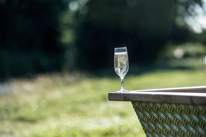 Have a glass of prosecco and relax in the hot tub at Hill Farm Glamping 