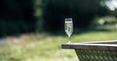 Have a glass of prosecco and relax in the hot tub at Hill Farm Glamping 