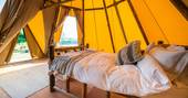 Interior of Slinket wth cosy double bed at Hill Farm Glamping in Warwickshire 
