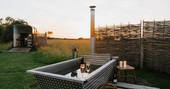 Slinket tipi hot tub on sunset, Priors Hardwick, Warwickshire