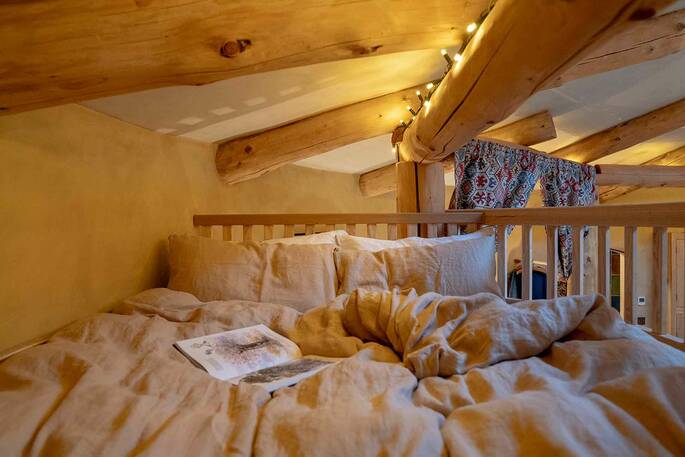 Double bed up on the mezzanine accessible by a ladder