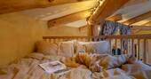 Double bed up on the mezzanine accessible by a ladder