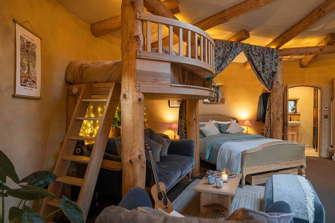 Ladder up to small mezzanine with double bed