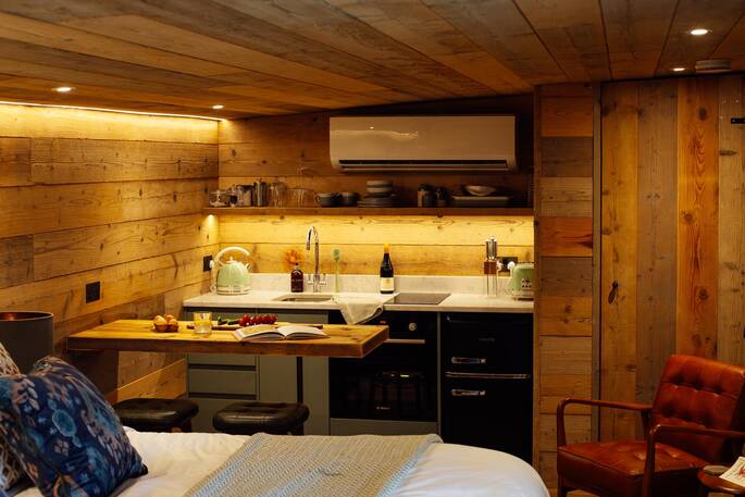 Kitchen equipped with a two-ring induction hob, undercounter fridge, oven, kettle and toaster