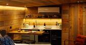Kitchen equipped with a two-ring induction hob, undercounter fridge, oven, kettle and toaster