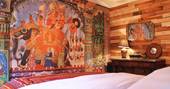 A view from the bed of the oriental painted wall in the master bedroom at Big Box in Wiltshire