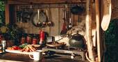 Kitchen equipped with a two ring gas hob and other utensils
