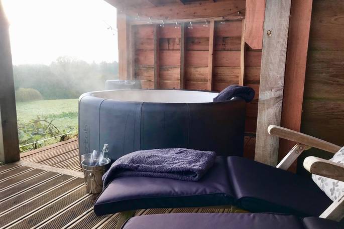 Relax in the hot tub and soak in the view at Oakdown Treehouse