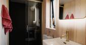 Bathroom with a hot shower, sink and flushing toilet