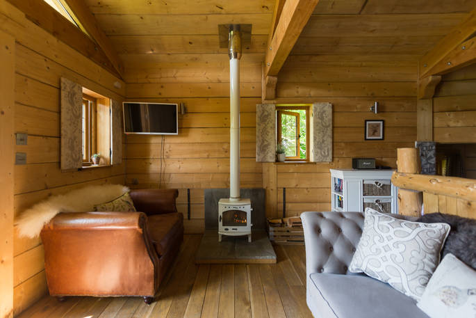 Treehouse living area featuring woodburner