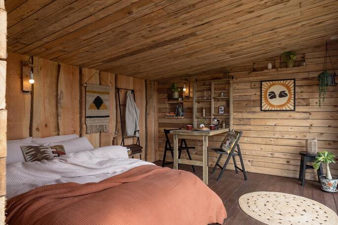 Open plan interior with indoor dining table and king size bed